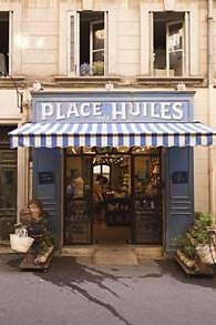 Vintage storefront with striped awning in France.