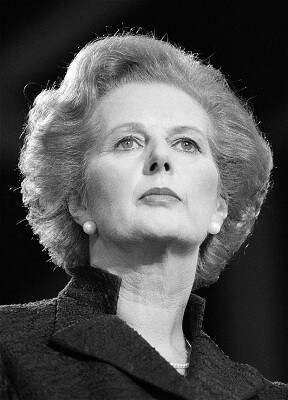 Black-and-white low-angle portrait of Margaret Thatcher looking upward.