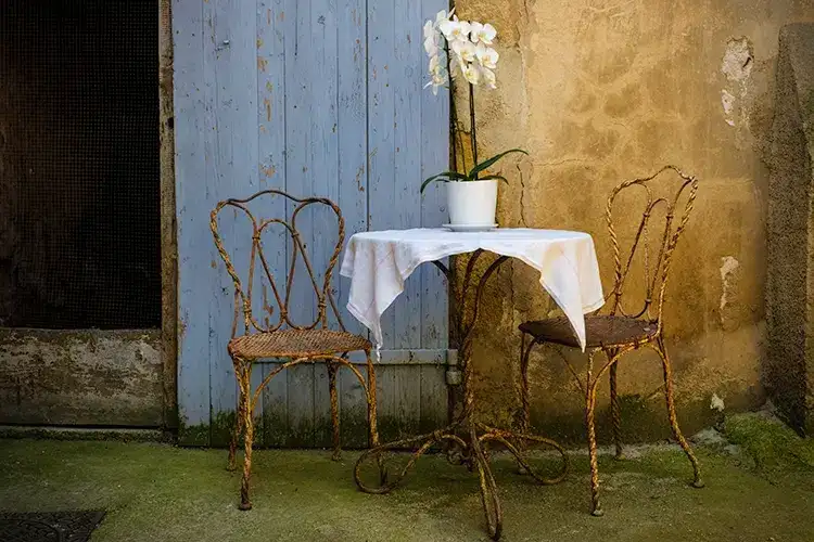 Rustic patio set with orchid on table